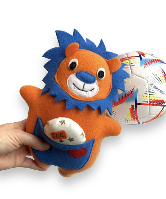 Orange and Blue Lion with a soccer ball in the background. a small ball in pocket all handmade